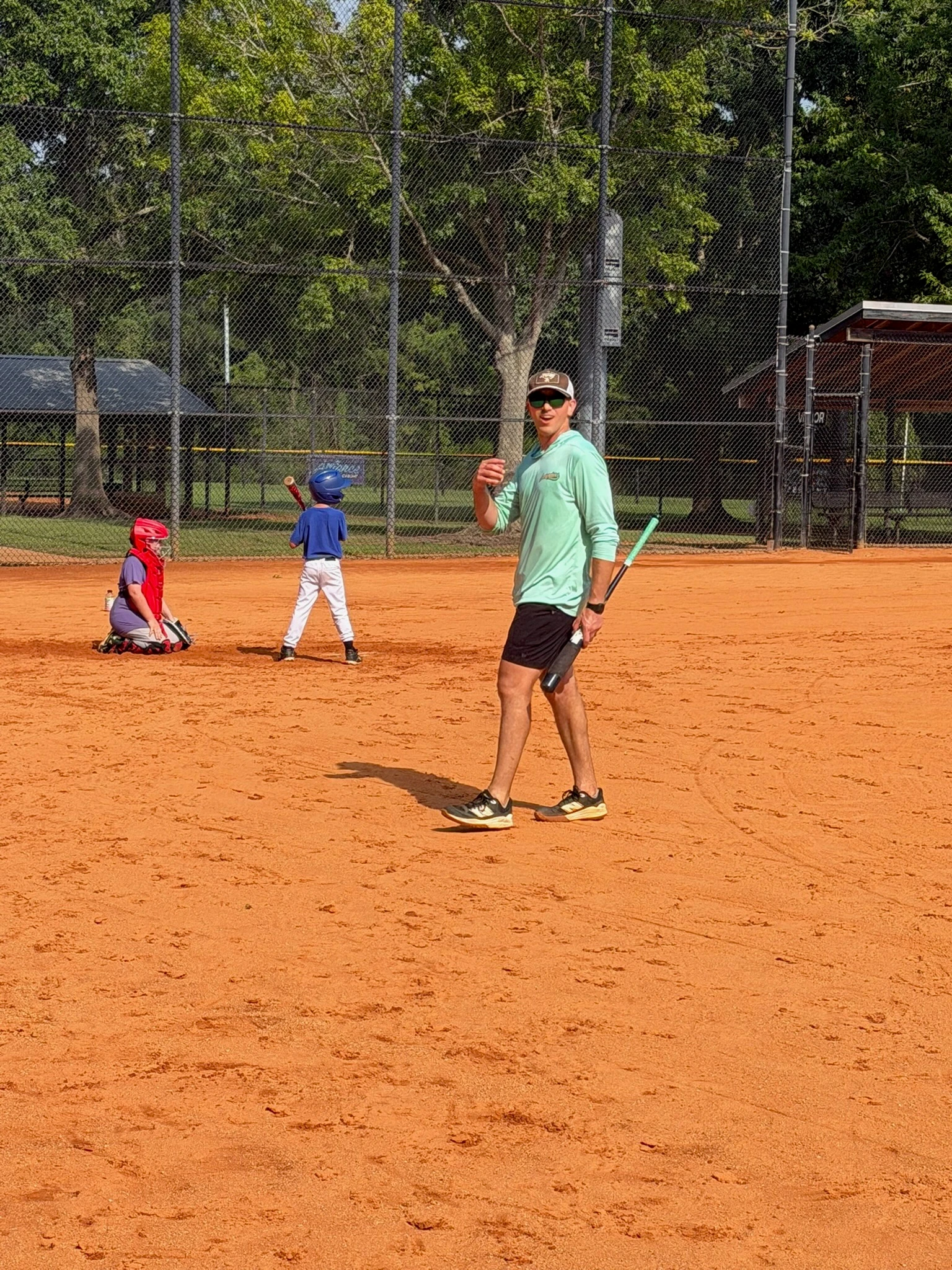 coach running live batting practice